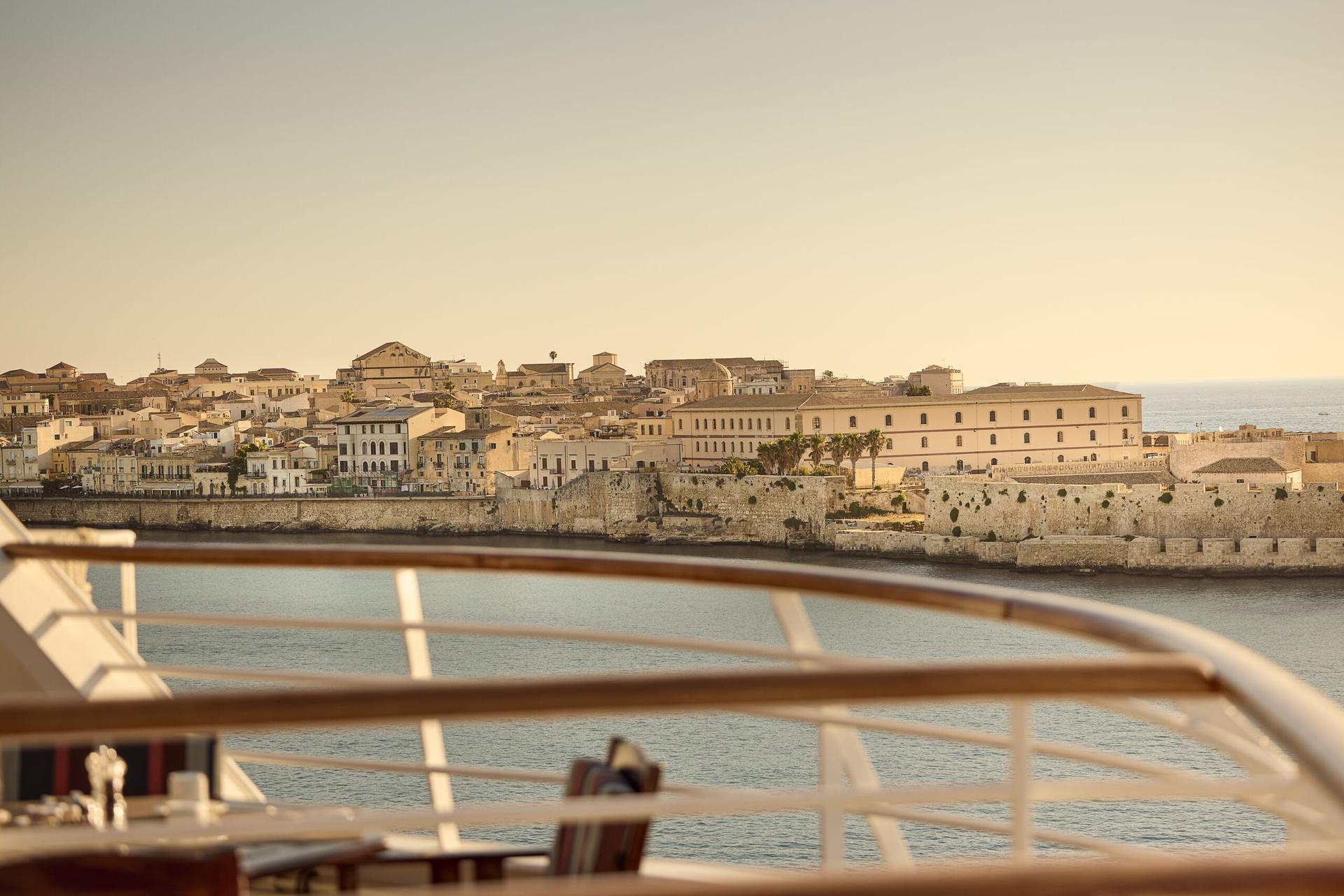 Two glamorous ladies stood on the deck of a ship